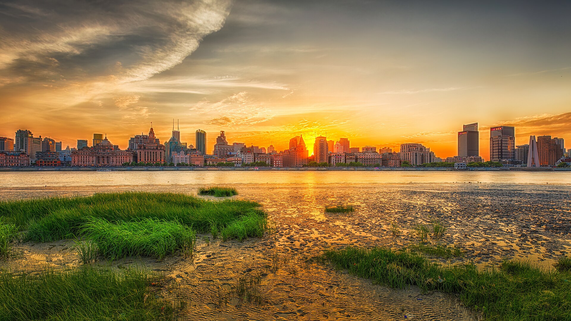 The historic Bund at sunset across the Huangpu River